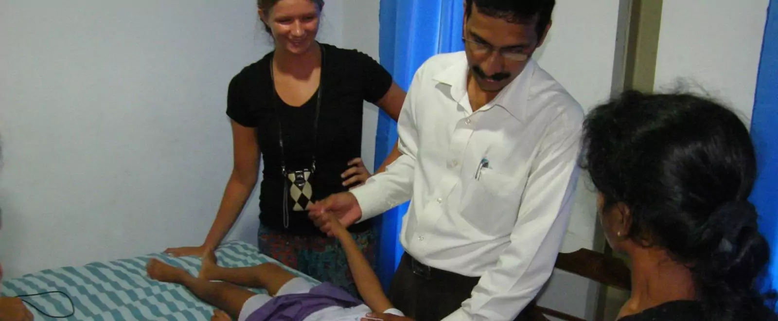 Physiotherapist treating a patient's back on a therapy couch